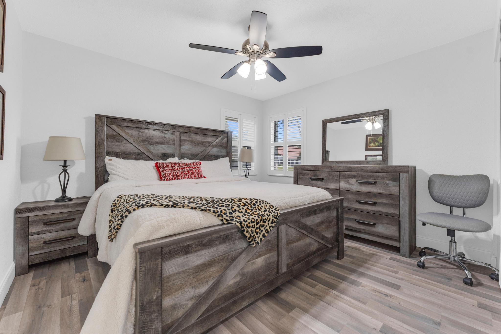 11120 Sangria Court Boca Raton, FL 33498 - Photo 17 of 34 a bedroom with a bed and a chandelier