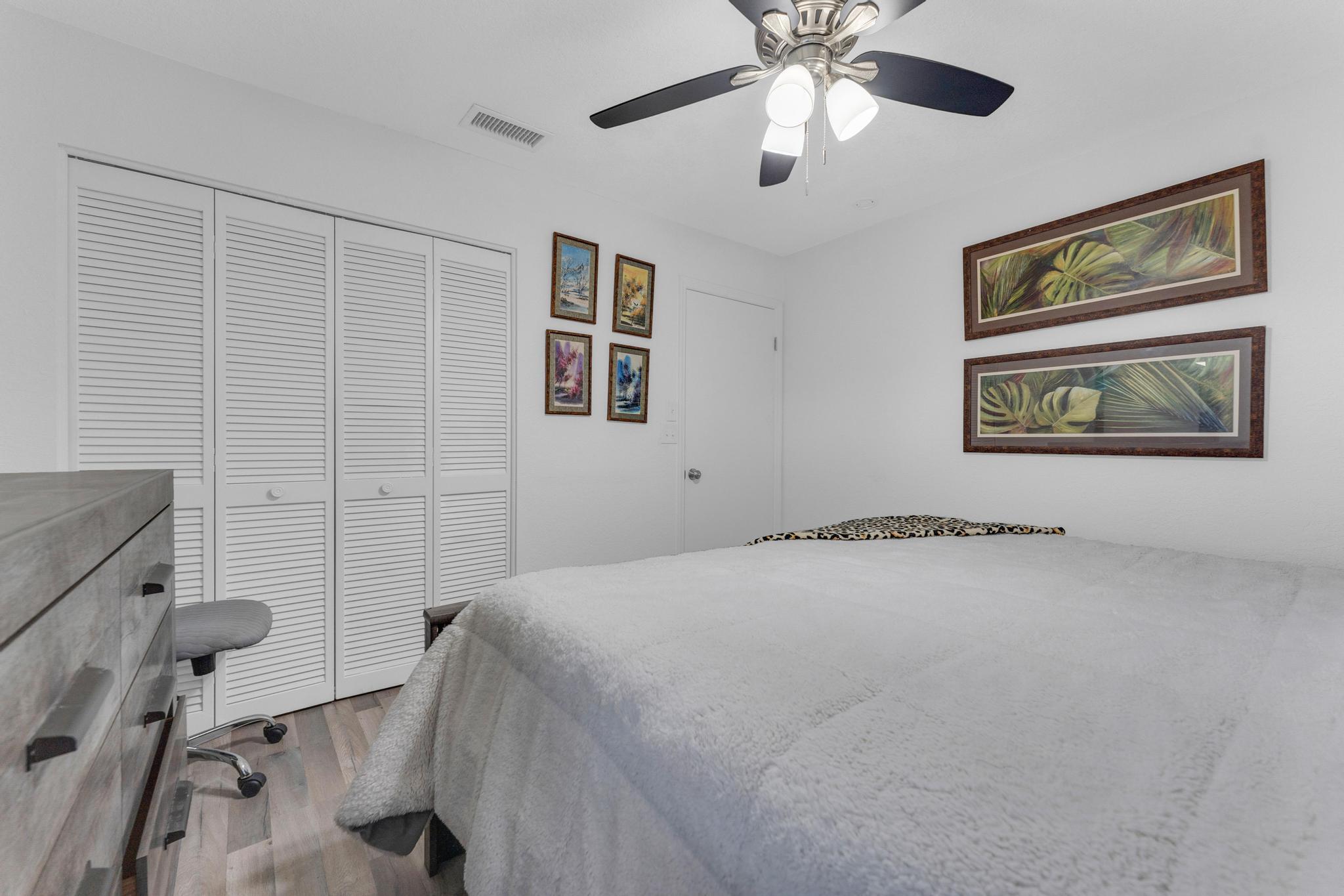 11120 Sangria Court Boca Raton, FL 33498 - Photo 18 of 34 a bedroom with a bed and a painting on the wall
