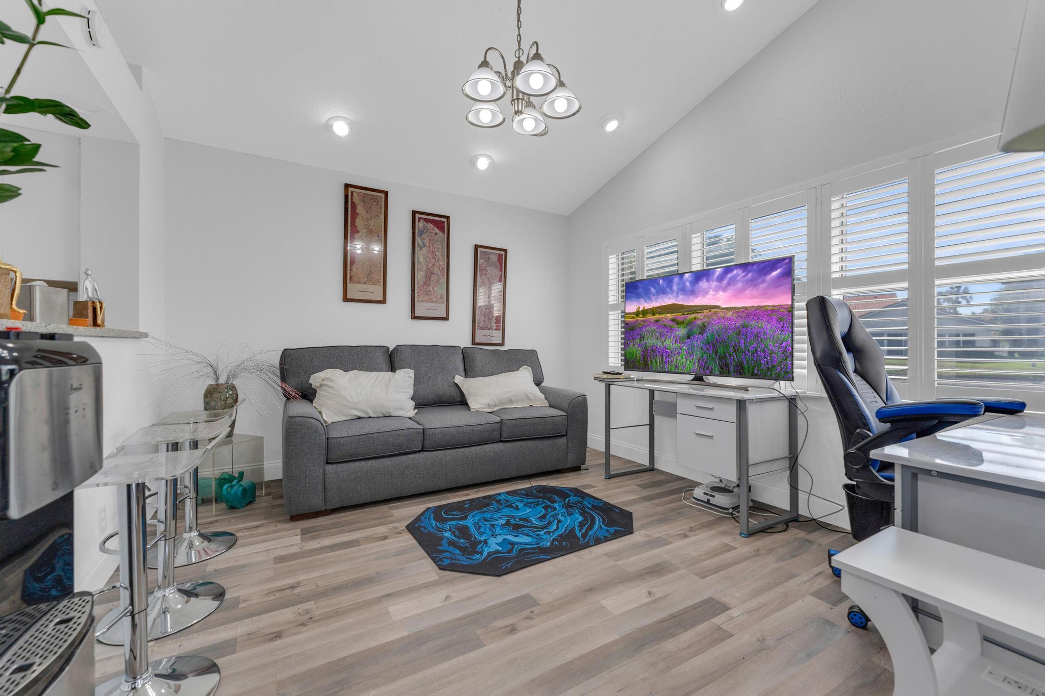 11120 Sangria Court Boca Raton, FL 33498 - Photo 21 of 34 a living room with furniture a flat screen tv and a window