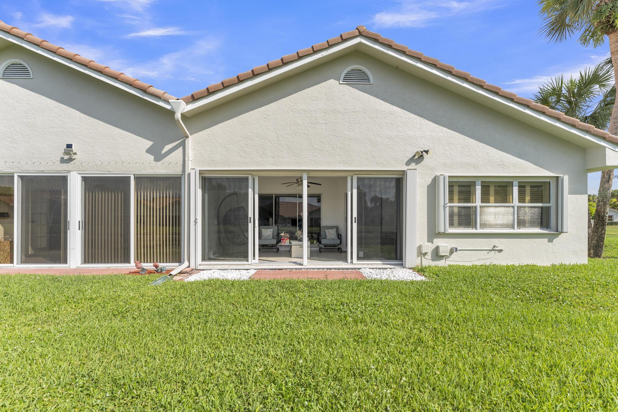 11120 Sangria Court Boca Raton, FL 33498 - Photo 32 of 34 a front view of a house with a yard
