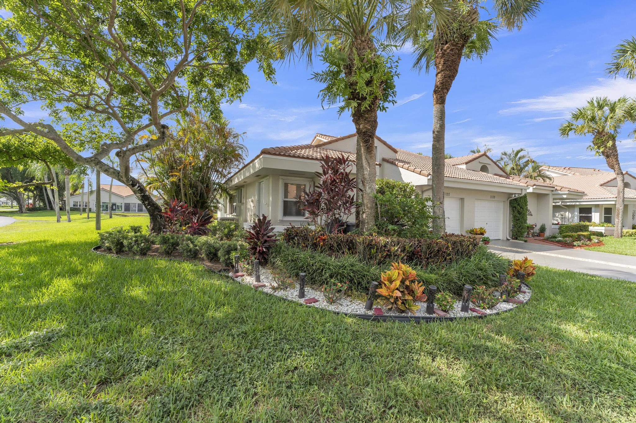 11120 Sangria Court Boca Raton, FL 33498 - Photo 4 of 34 a front view of a house with garden and tree