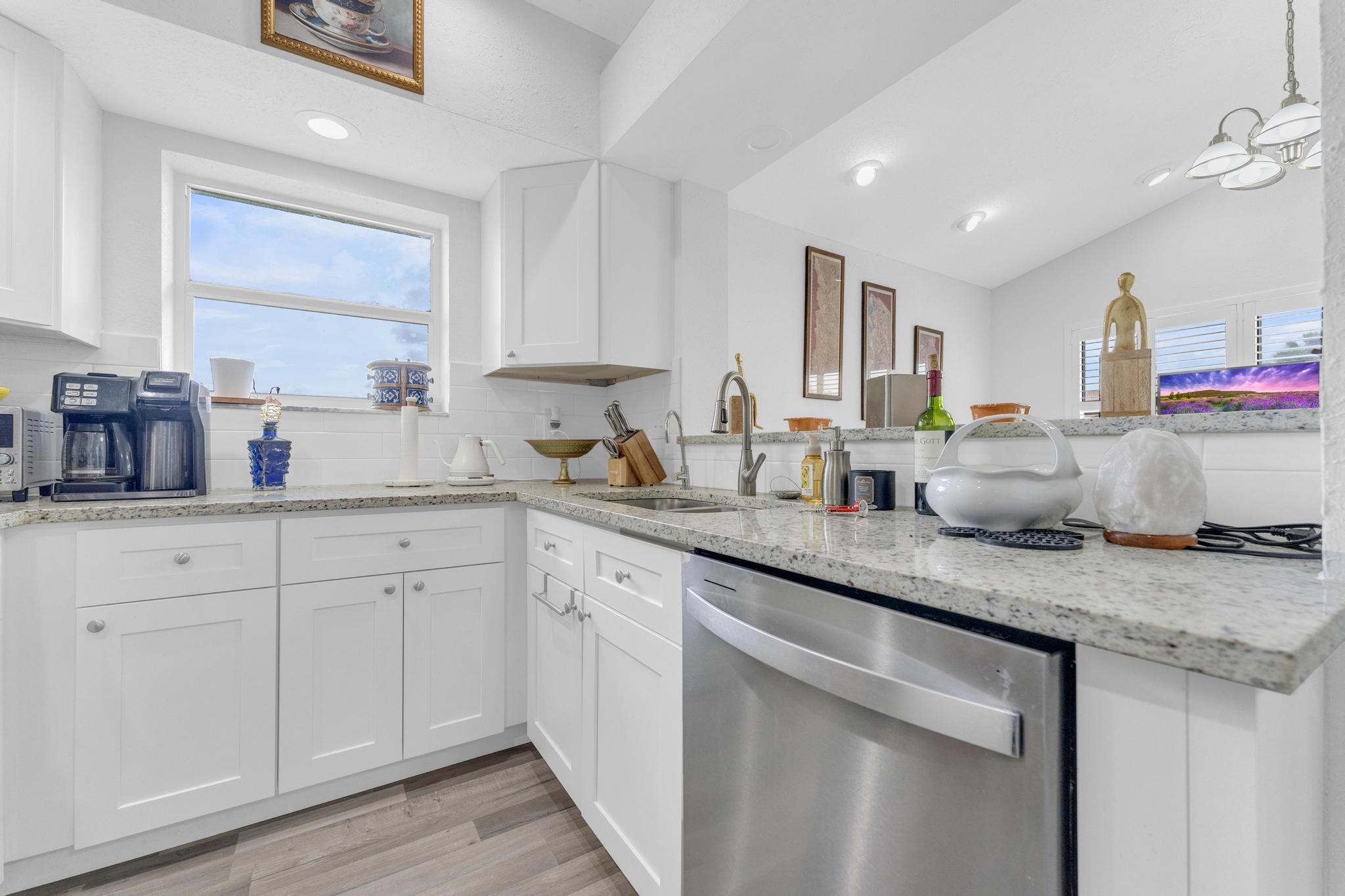 11120 Sangria Court Boca Raton, FL 33498 - Photo 7 of 34 a kitchen with granite countertop white cabinets and white stainless steel appliances