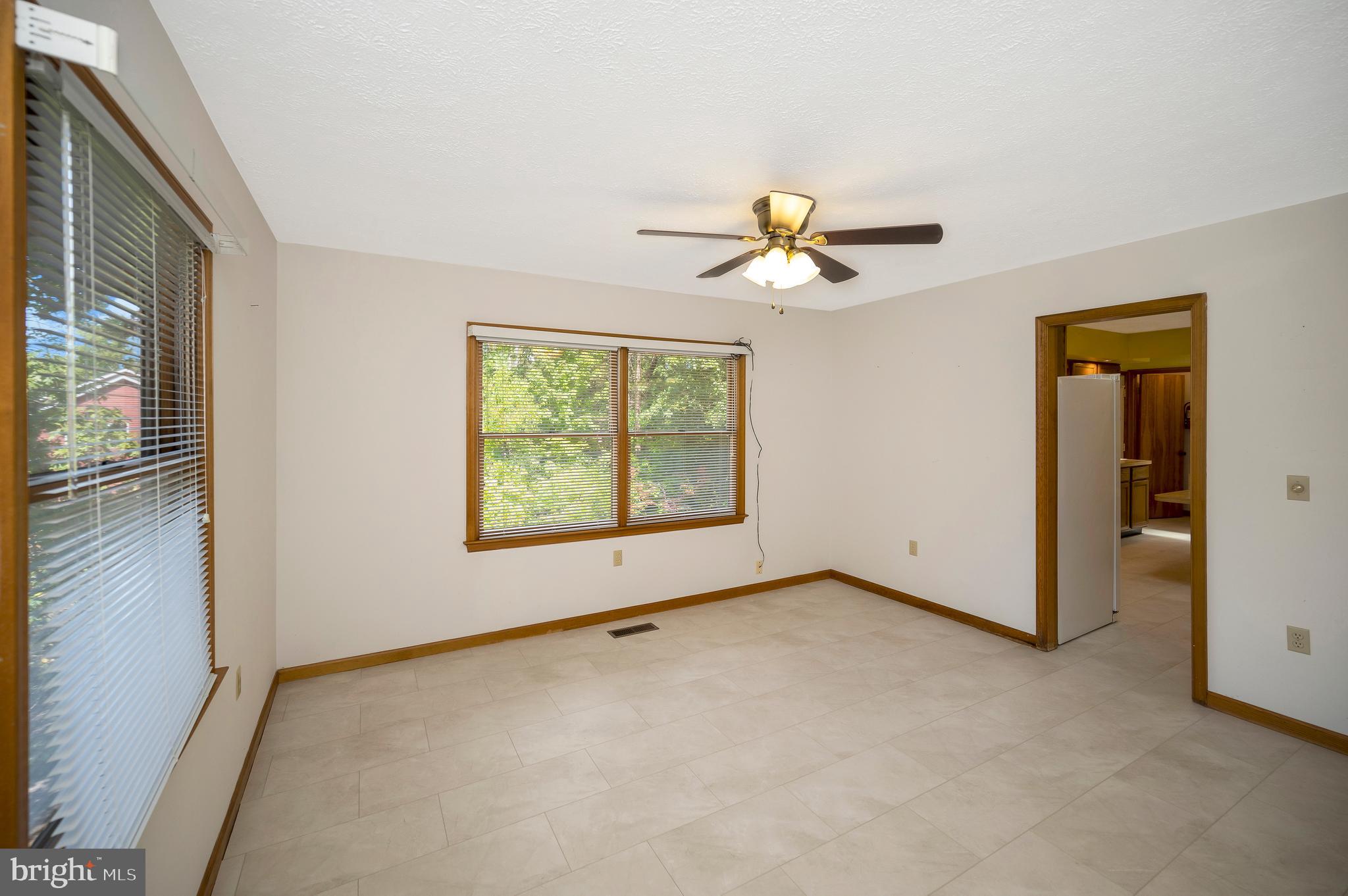 204 Freedom Road Locust Grove, VA 22508 - Photo 12 of 42 an empty room with windows and ceiling fan