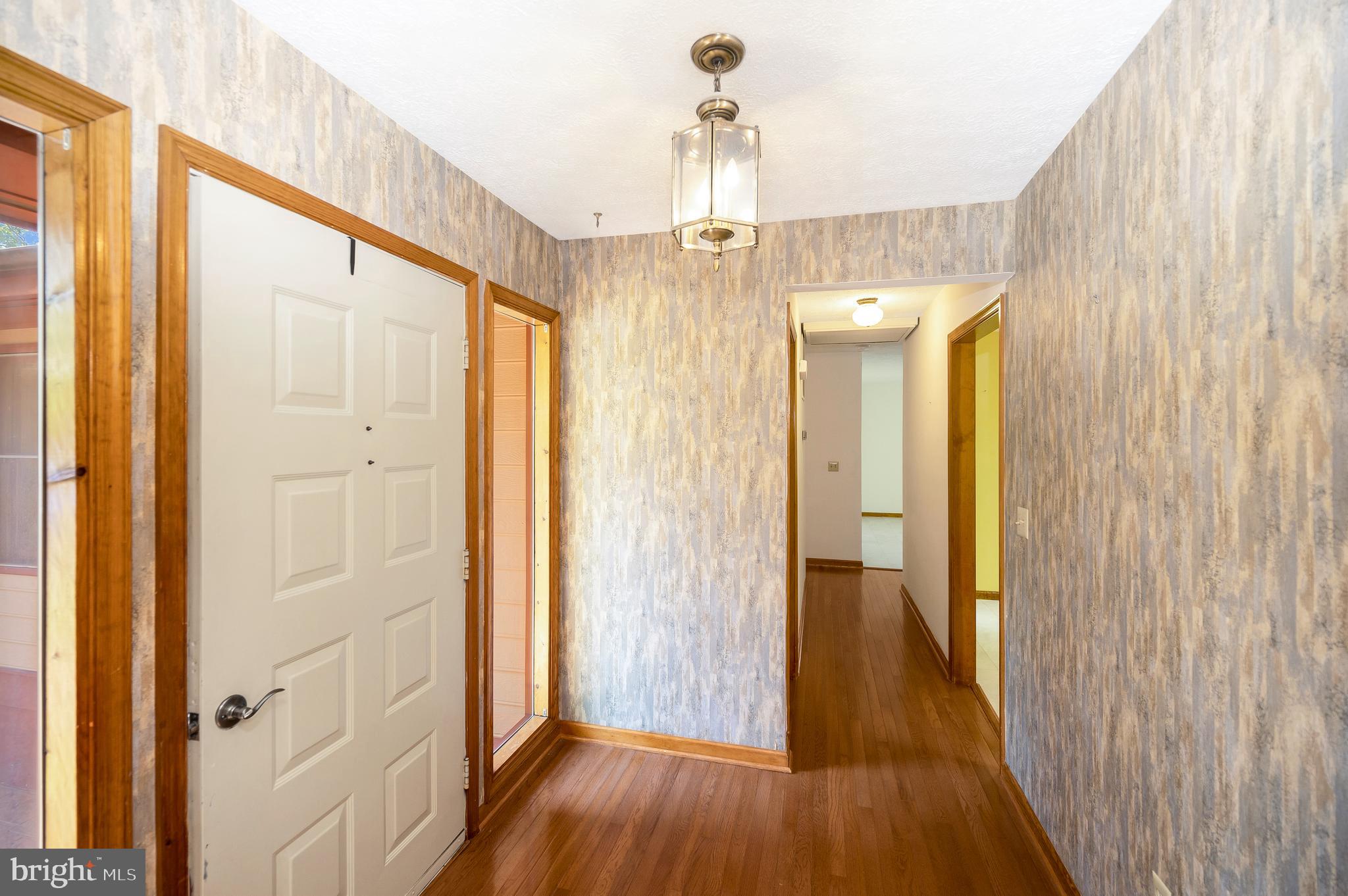 204 Freedom Road Locust Grove, VA 22508 - Photo 13 of 42 a view of a hallway with wooden floor and chandelier