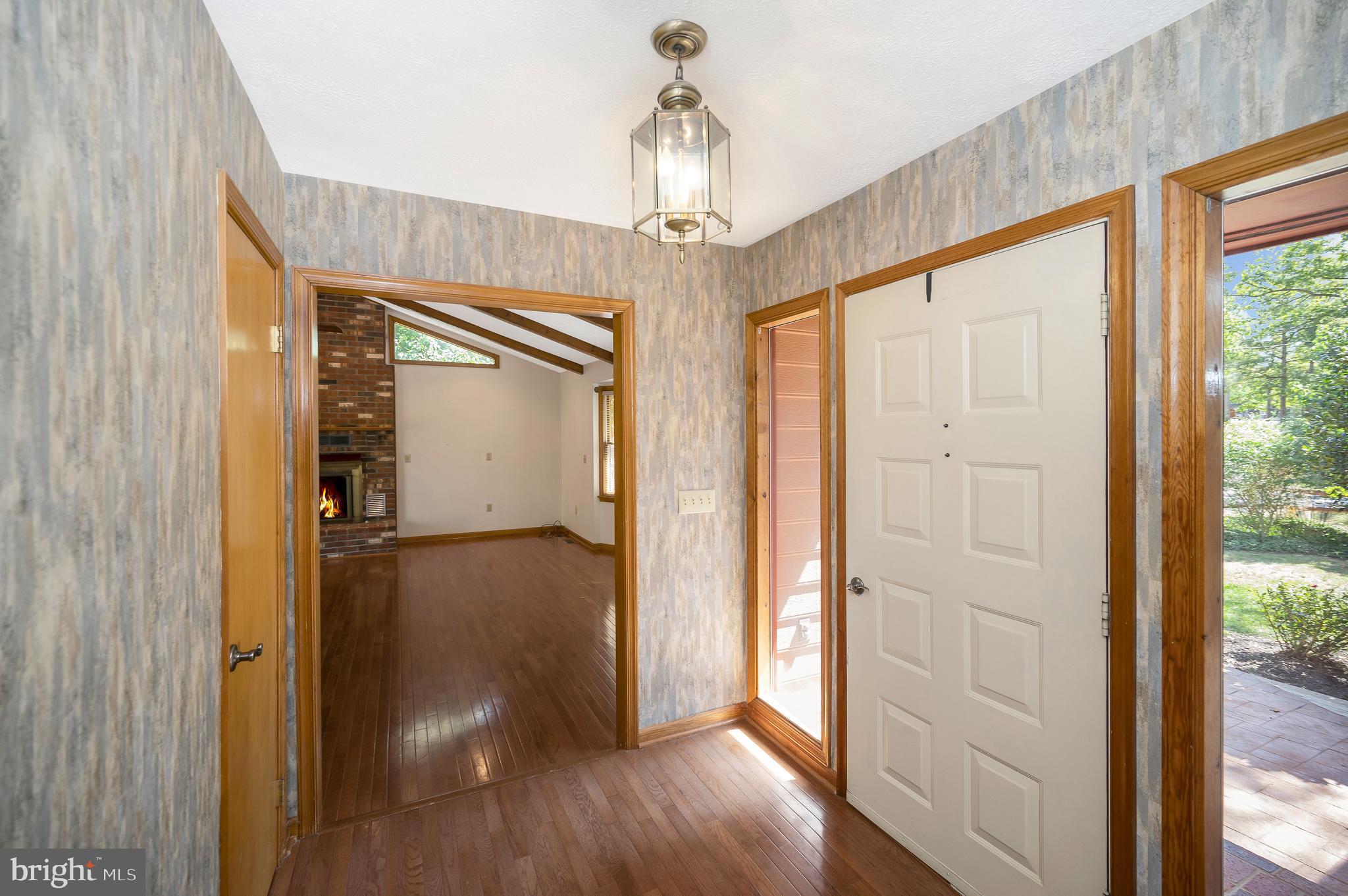 204 Freedom Road Locust Grove, VA 22508 - Photo 5 of 42 a view of a hallway with wooden floor and a chandelier