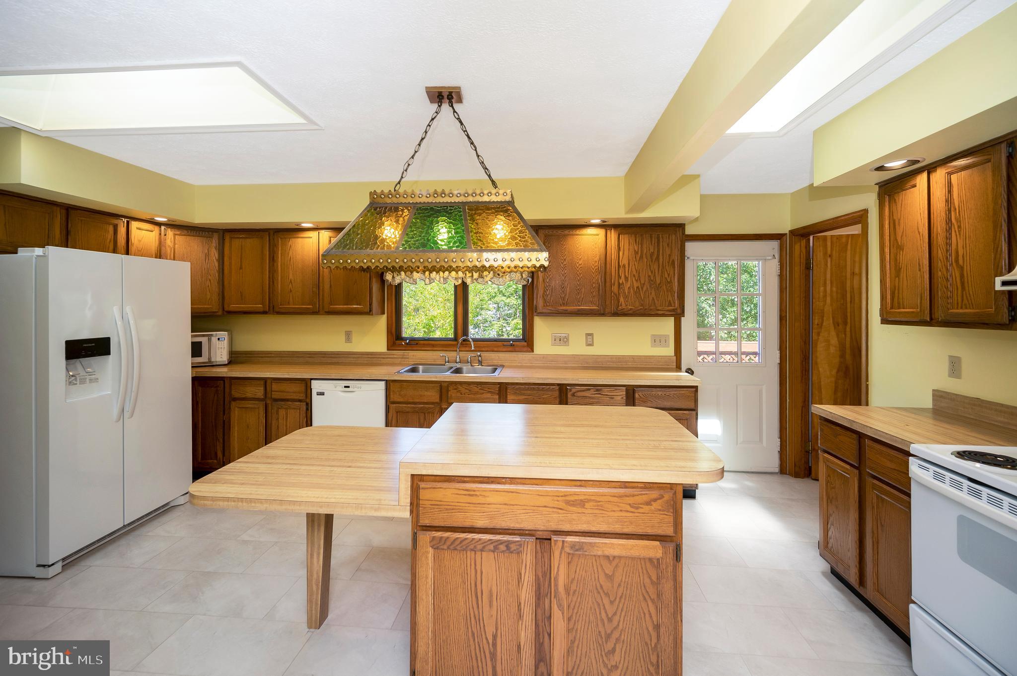 204 Freedom Road Locust Grove, VA 22508 - Photo 8 of 42 a kitchen with a stove a refrigerator and a fireplace