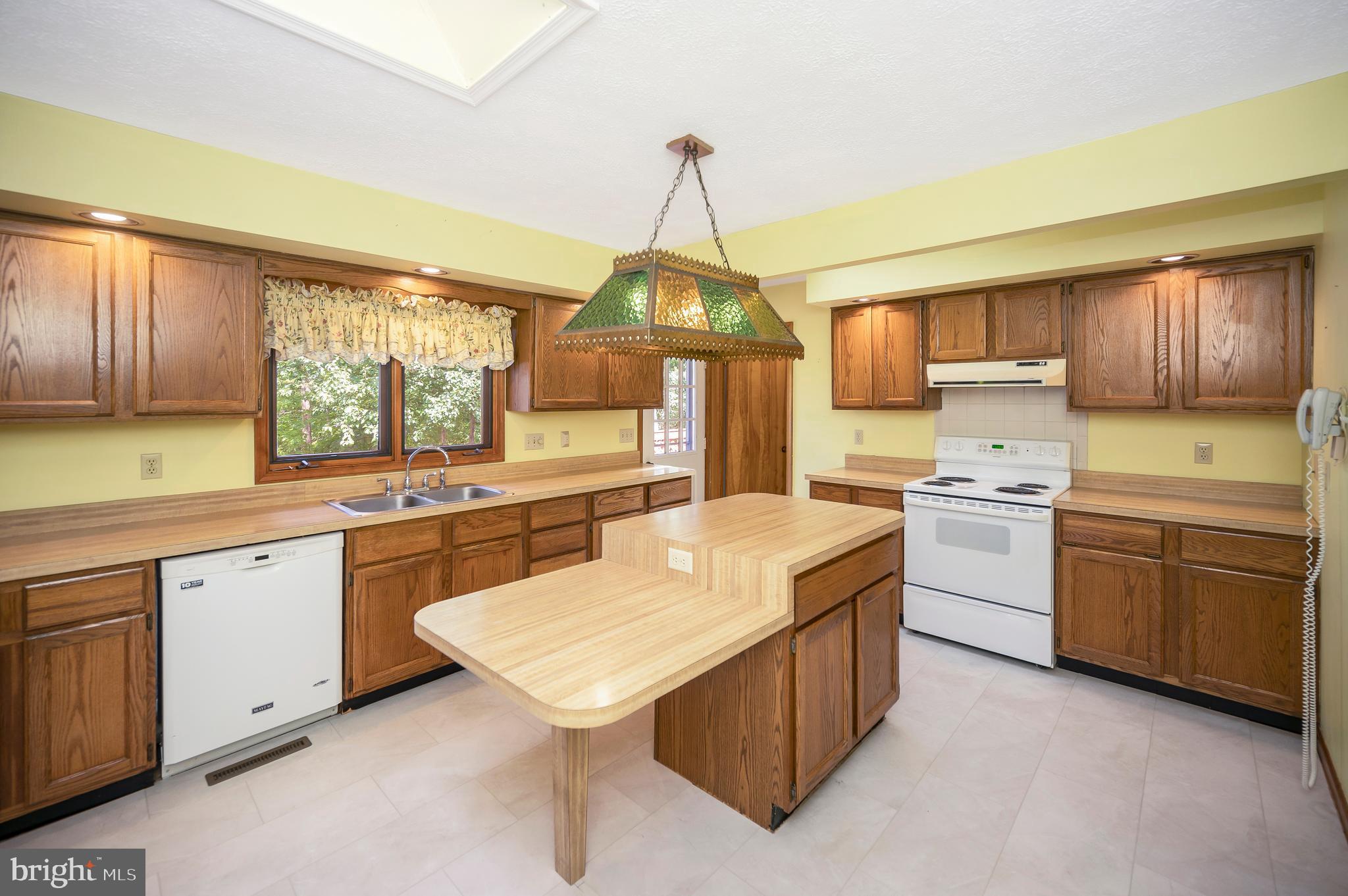 204 Freedom Road Locust Grove, VA 22508 - Photo 9 of 42 a kitchen with a sink stove and wooden cabinets