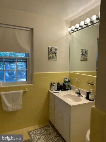 a bathroom with a sink a mirror and a bathtub