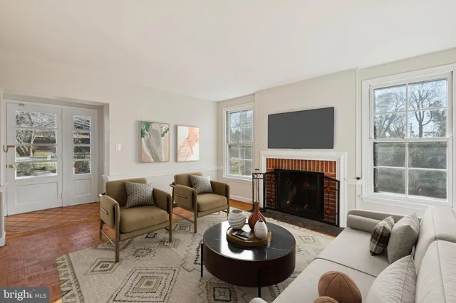 a living room with furniture a fireplace and windows
