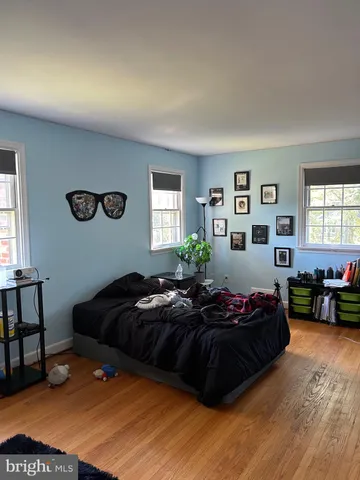 a bedroom with a bed window and couch