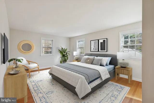 a bedroom with a bed and painting on the wall