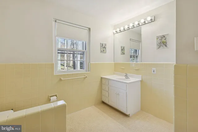 a bathroom with a sink a mirror and a bathtub
