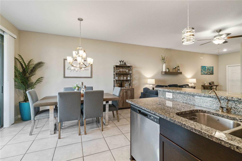 14339 Easy Goer Street Ruskin, FL 33573 - Photo 25 of 71 a view of a dining room kitchen and a chandelier