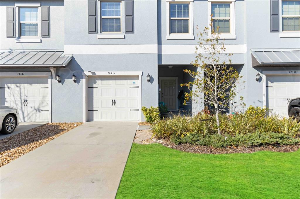 14339 Easy Goer Street Ruskin, FL 33573 - Photo 4 of 71 a front view of a house with garden