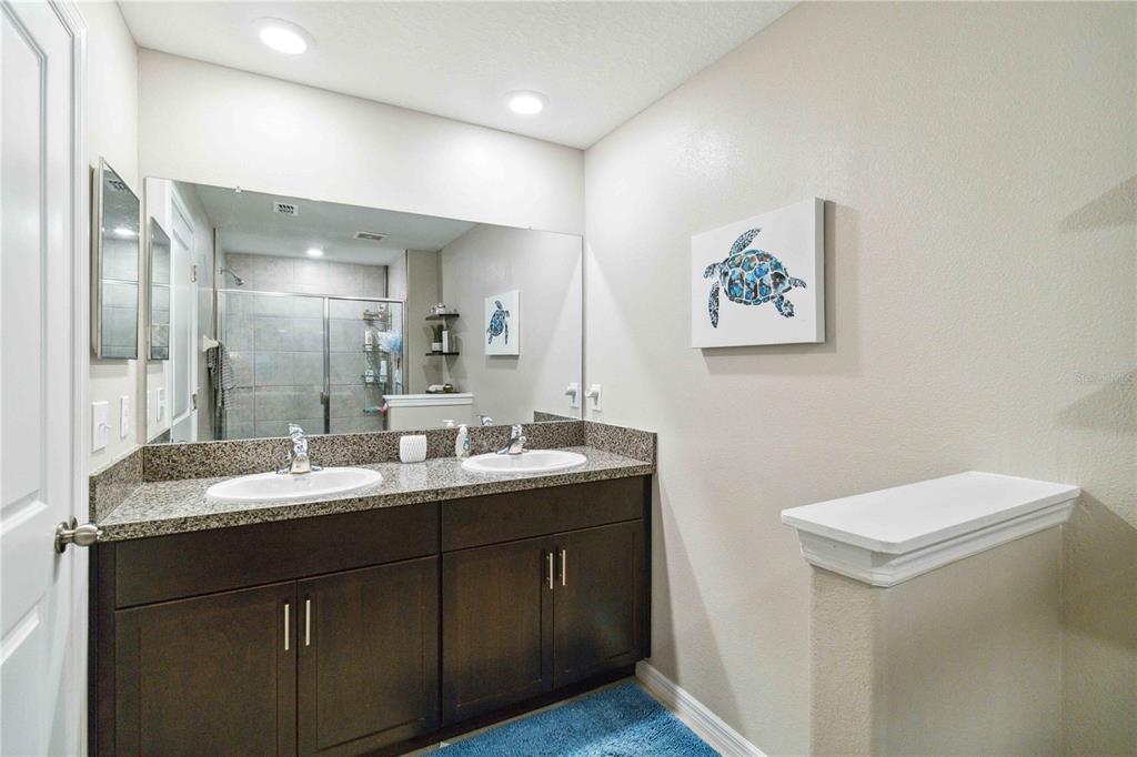 14339 Easy Goer Street Ruskin, FL 33573 - Photo 43 of 71 a bathroom with a granite countertop sink a toilet and a mirror