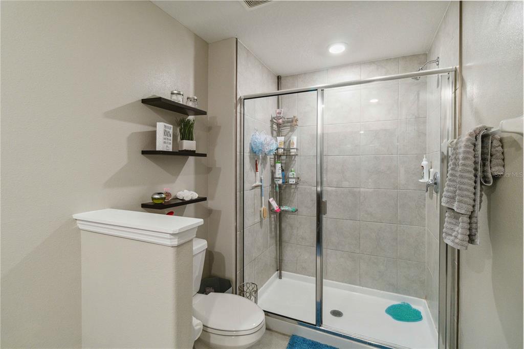 14339 Easy Goer Street Ruskin, FL 33573 - Photo 45 of 71 a bathroom with a shower a toilet and a sink