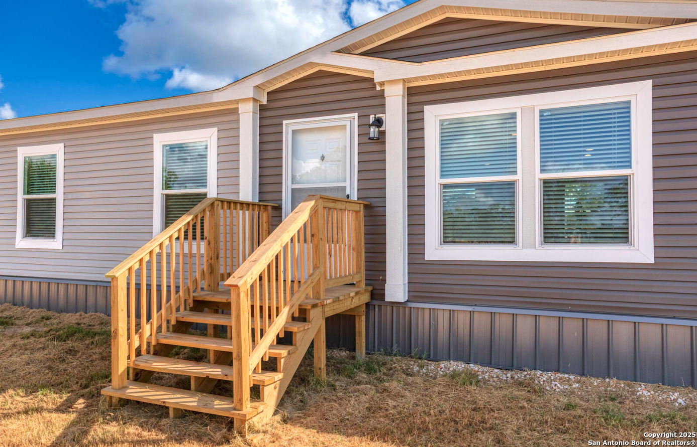 4124 Wegner Road New Braunfels, TX 78132 - Photo 3 of 12 a view of wooden house with a large window