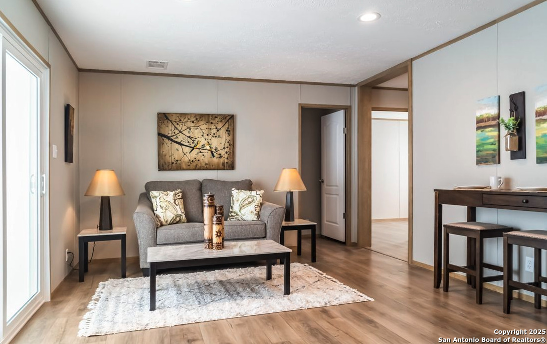 4124 Wegner Road New Braunfels, TX 78132 - Photo 7 of 12 a living room with furniture and a painting on the wall