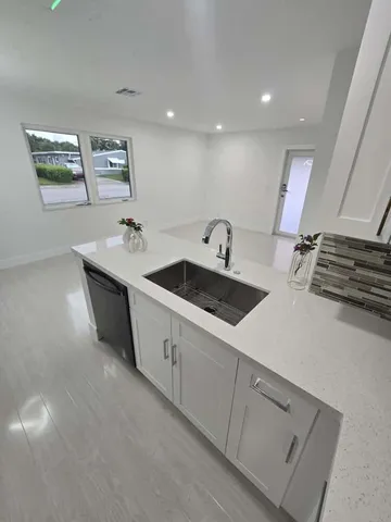 a kitchen with stainless steel appliances a sink and a stove