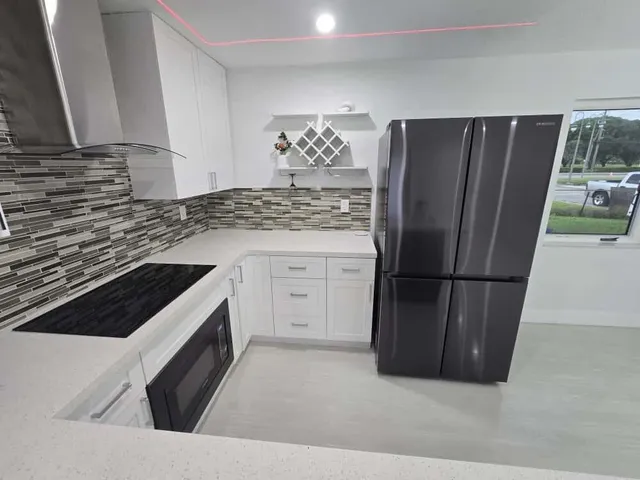 a kitchen with a stove a refrigerator and a fireplace
