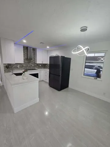 a kitchen with stainless steel appliances granite countertop a stove and a refrigerator