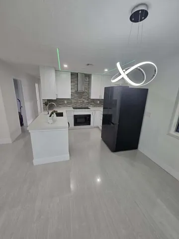 a living room with furniture and kitchen view