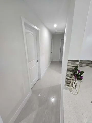 a view of a hallway with seating area