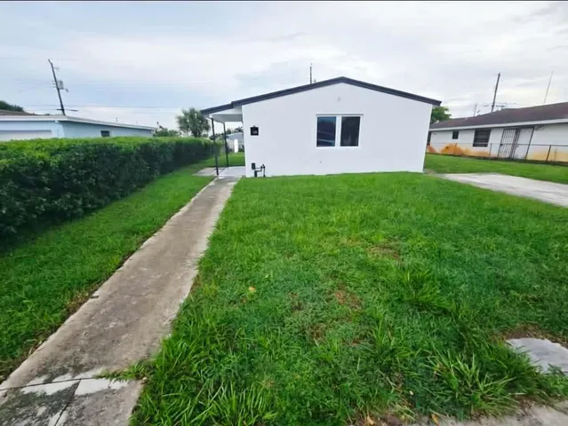 a house with a yard and a large window