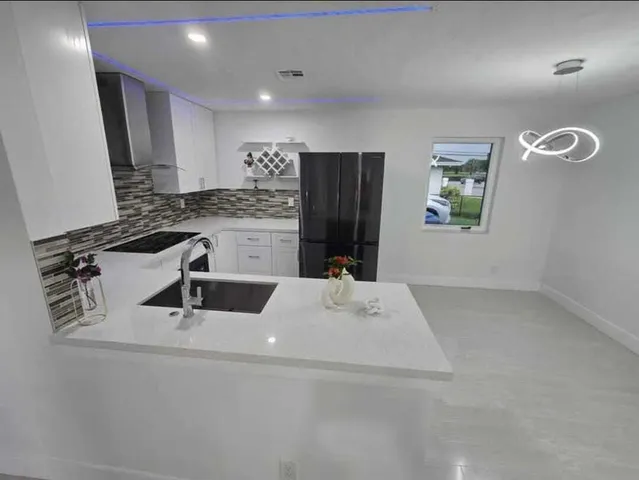 a kitchen with a sink and a refrigerator