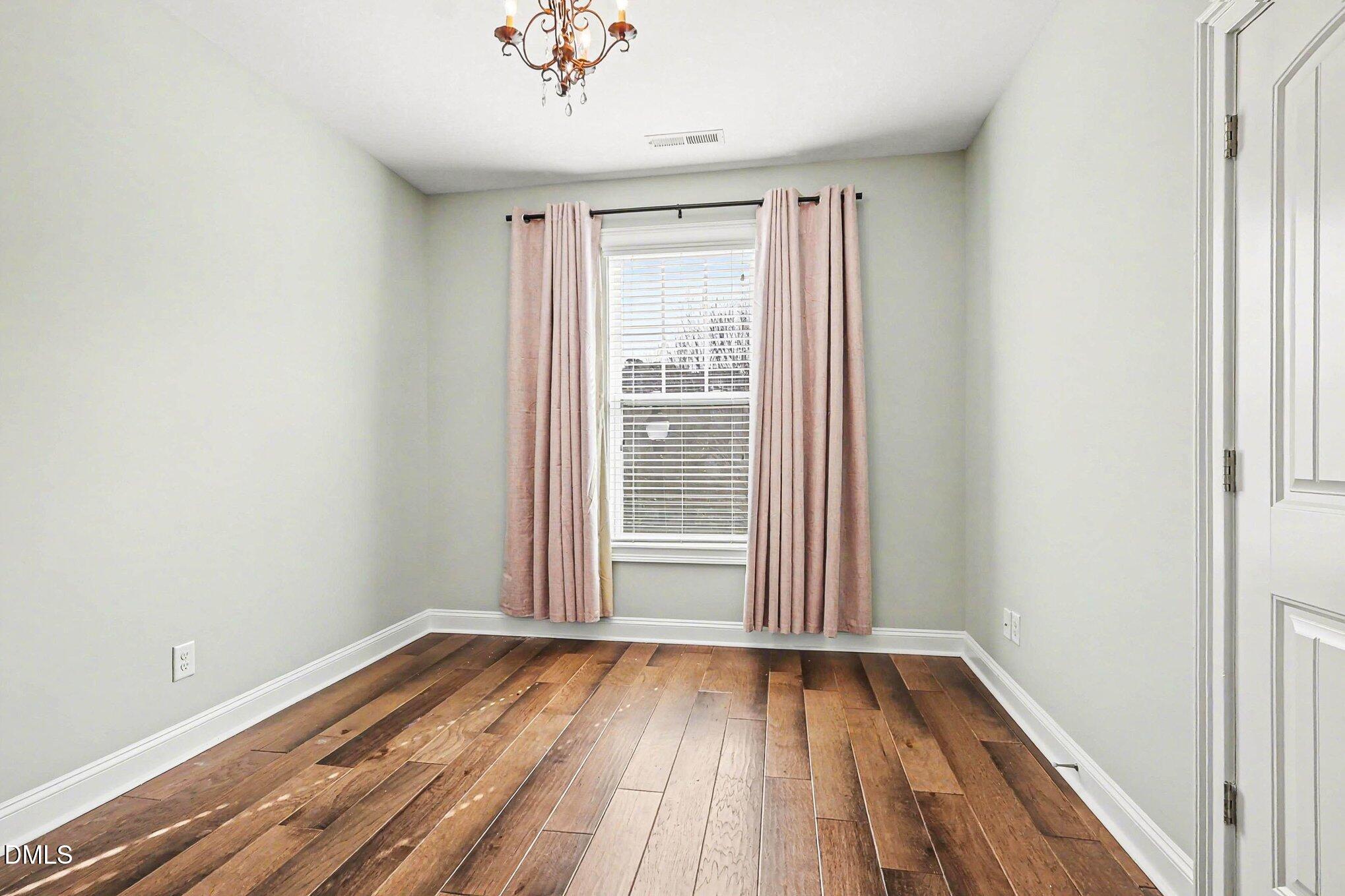 653 Fallon Grove Way Raleigh, NC 27608 - Photo 12 of 38 a view of a room with wooden floor and window