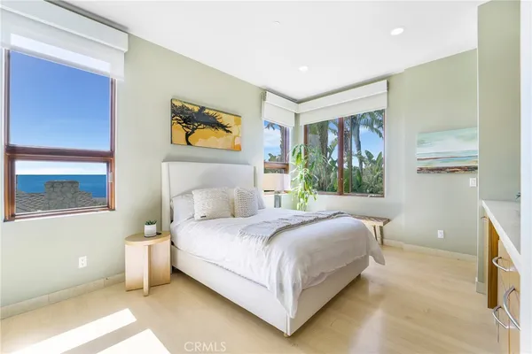 a bedroom with a bed and a painting on the wall