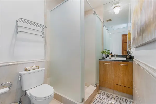 a bathroom with a toilet a sink and a mirror