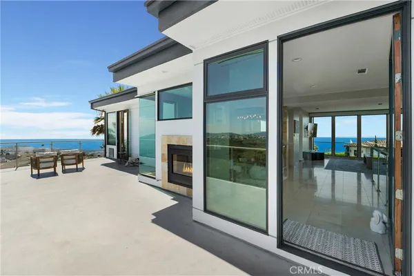 a view of a livingroom with furniture and floor to ceiling window