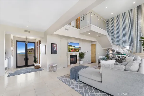 a living room with furniture and kitchen view