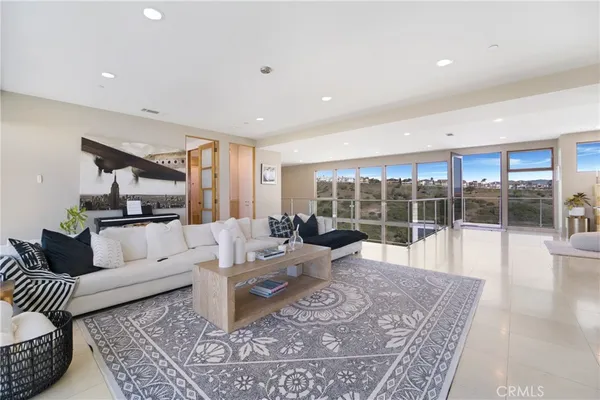 a living room with furniture large window and a table