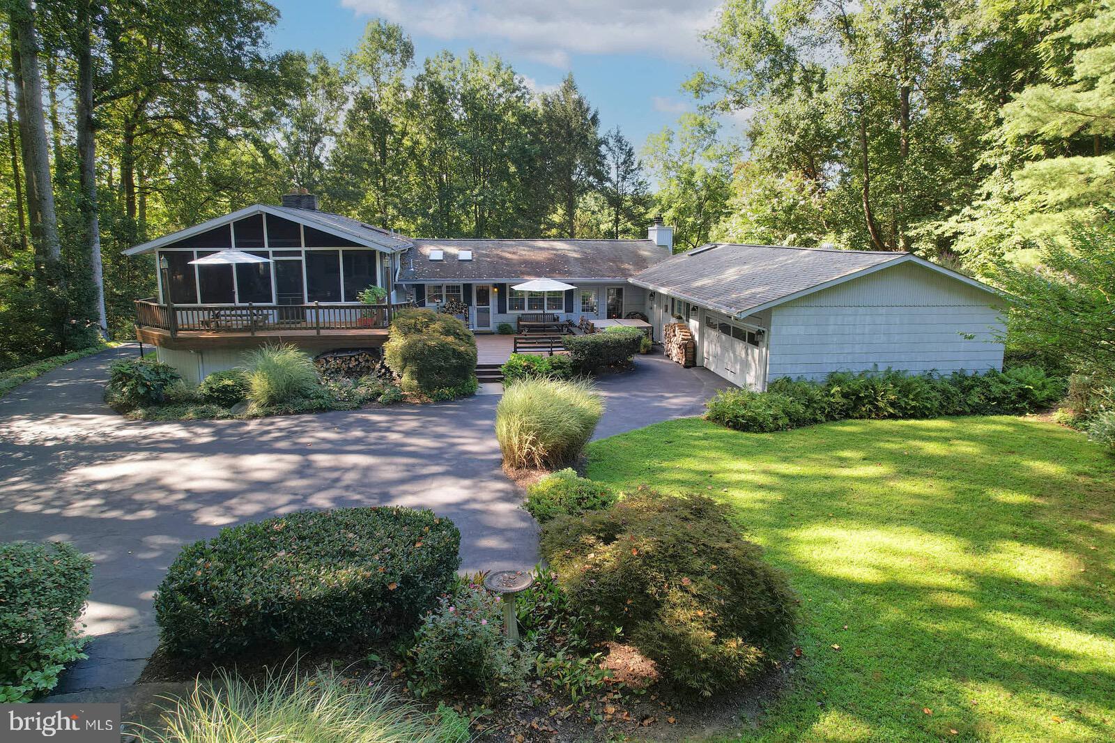 a aerial view of a house next to a big yard and large trees