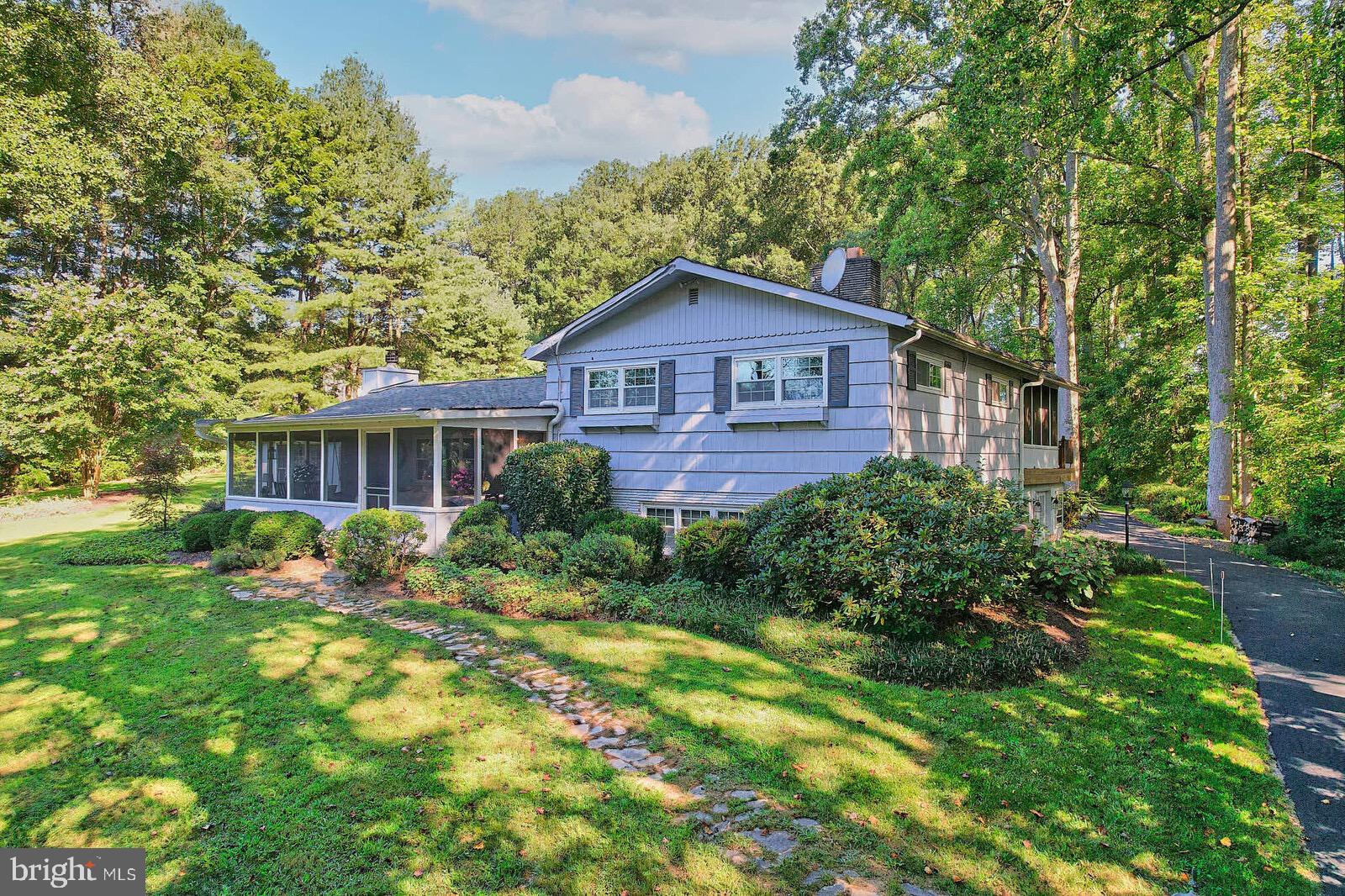31 Haviland Mill Road Brinklow, MD 20862 - Photo 11 of 36 a brick house with a big yard and large trees