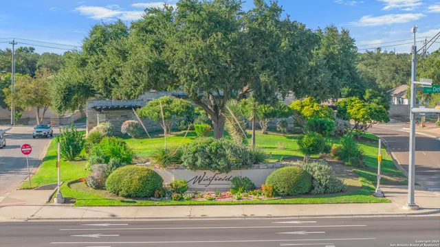 a front view of a house with a yard and potted plants