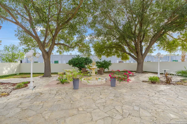 a view of a patio with table and chairs under an umbrella