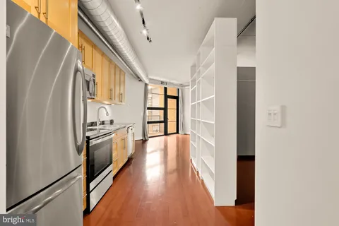 a view of a kitchen with a refrigerator a stove top oven