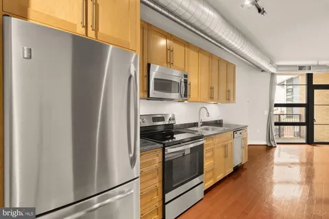 a kitchen with stainless steel appliances a refrigerator stove and sink