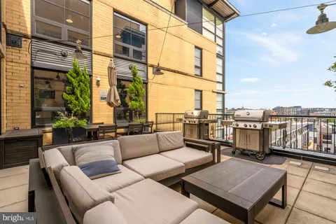 a terrace with outdoor seating and city view