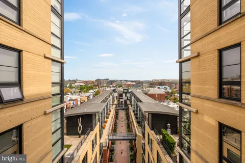 a view of a roof deck with building and ocean view