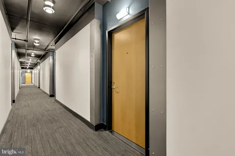 a view of hallway with wooden floor