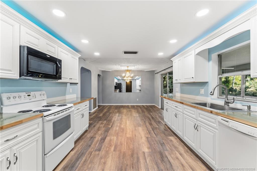 1201 Oak Avenue Fort Pierce, FL 34982 - Photo 11 of 43 a kitchen with kitchen island granite countertop a sink and steel appliances