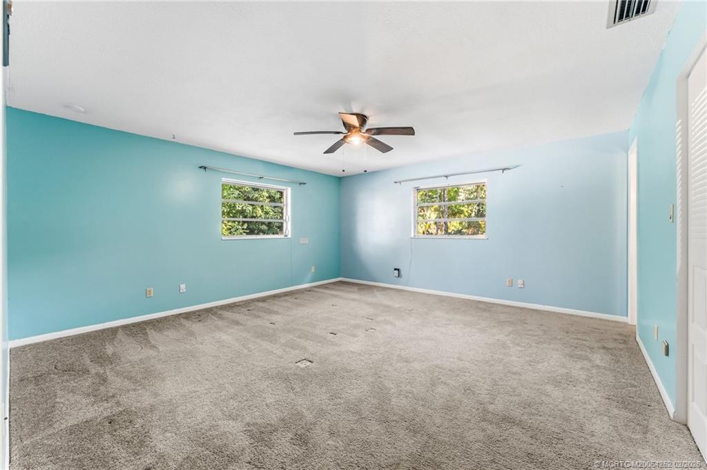 1201 Oak Avenue Fort Pierce, FL 34982 - Photo 21 of 43 an empty room with windows and ceiling fan