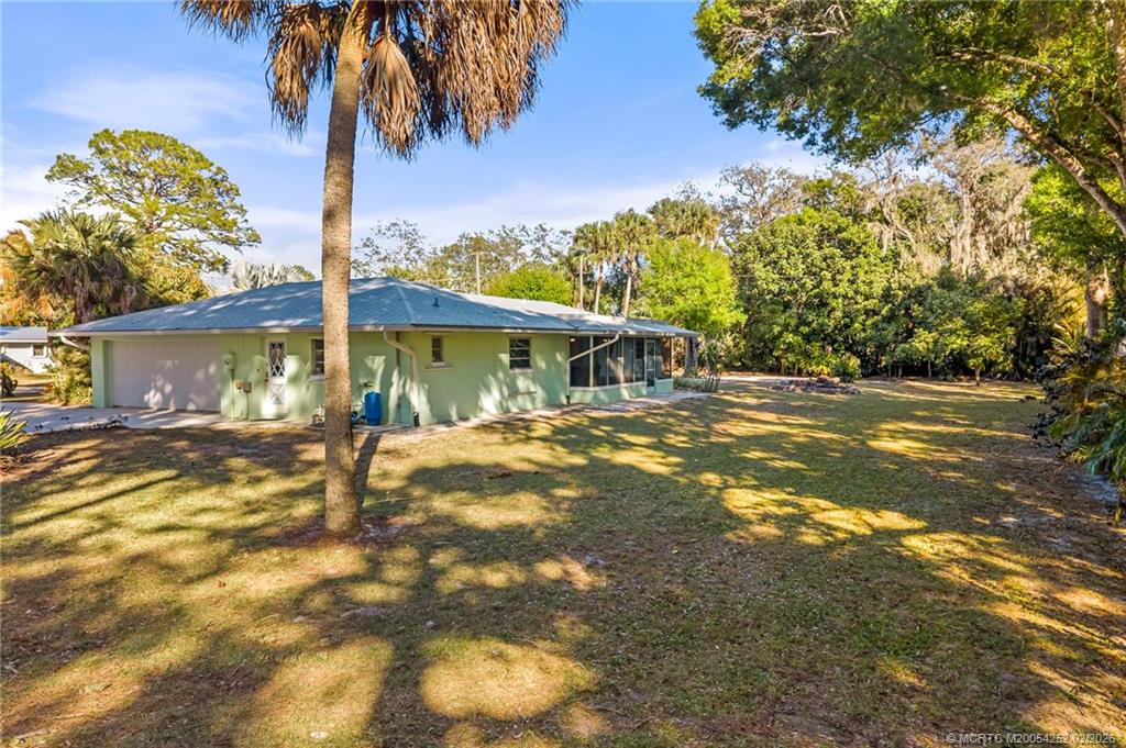 1201 Oak Avenue Fort Pierce, FL 34982 - Photo 32 of 43 a view of a house with backyard and a tree