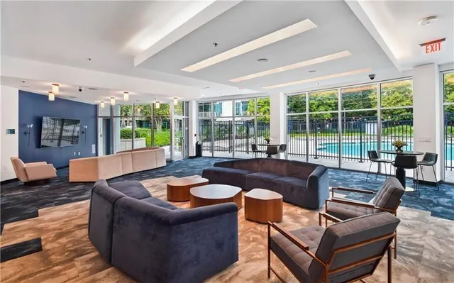 a living room with furniture and a large window