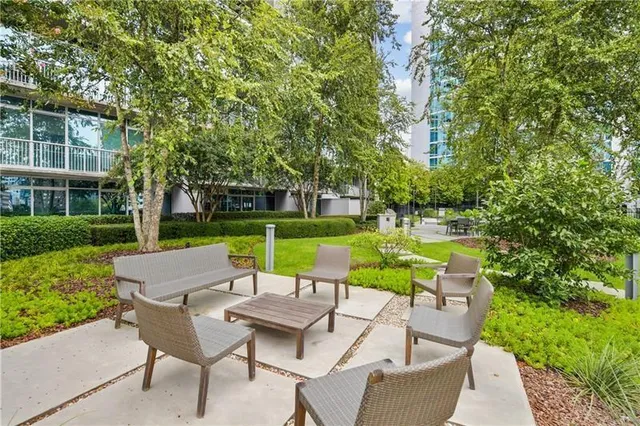 a view of a table and chairs in backyard of the house