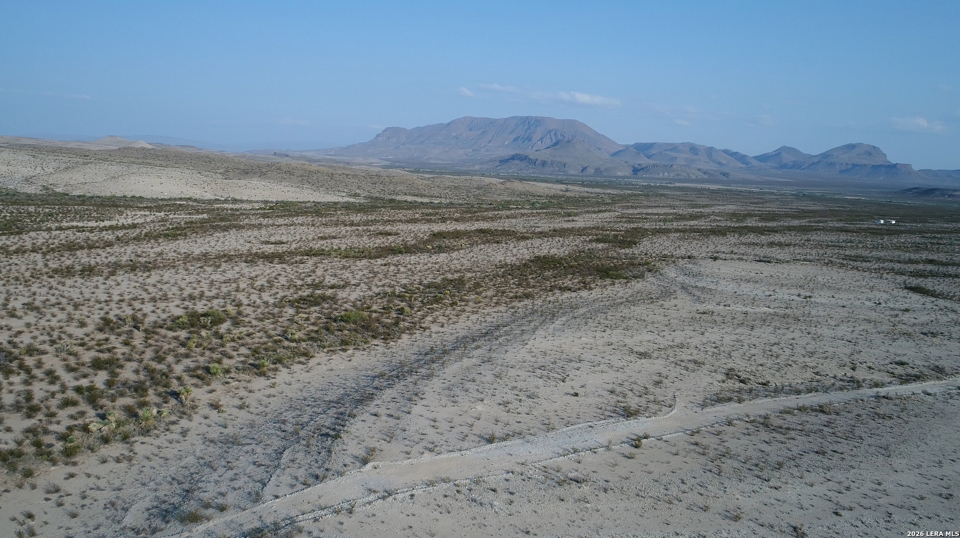 a view of an ocean beach and mountain
